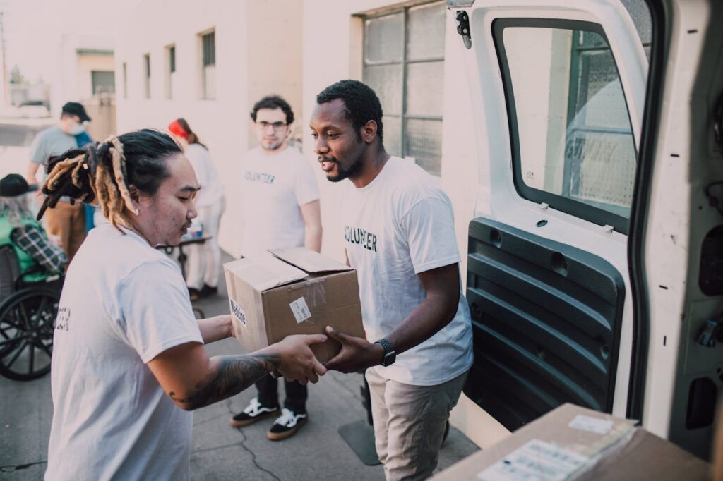 Services Volunteers working together to distribute donated supplies from a van.