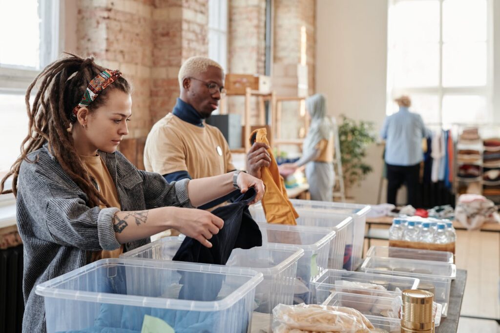 Services Volunteers organize donated clothing at a donation center, fostering community support and sustainability.